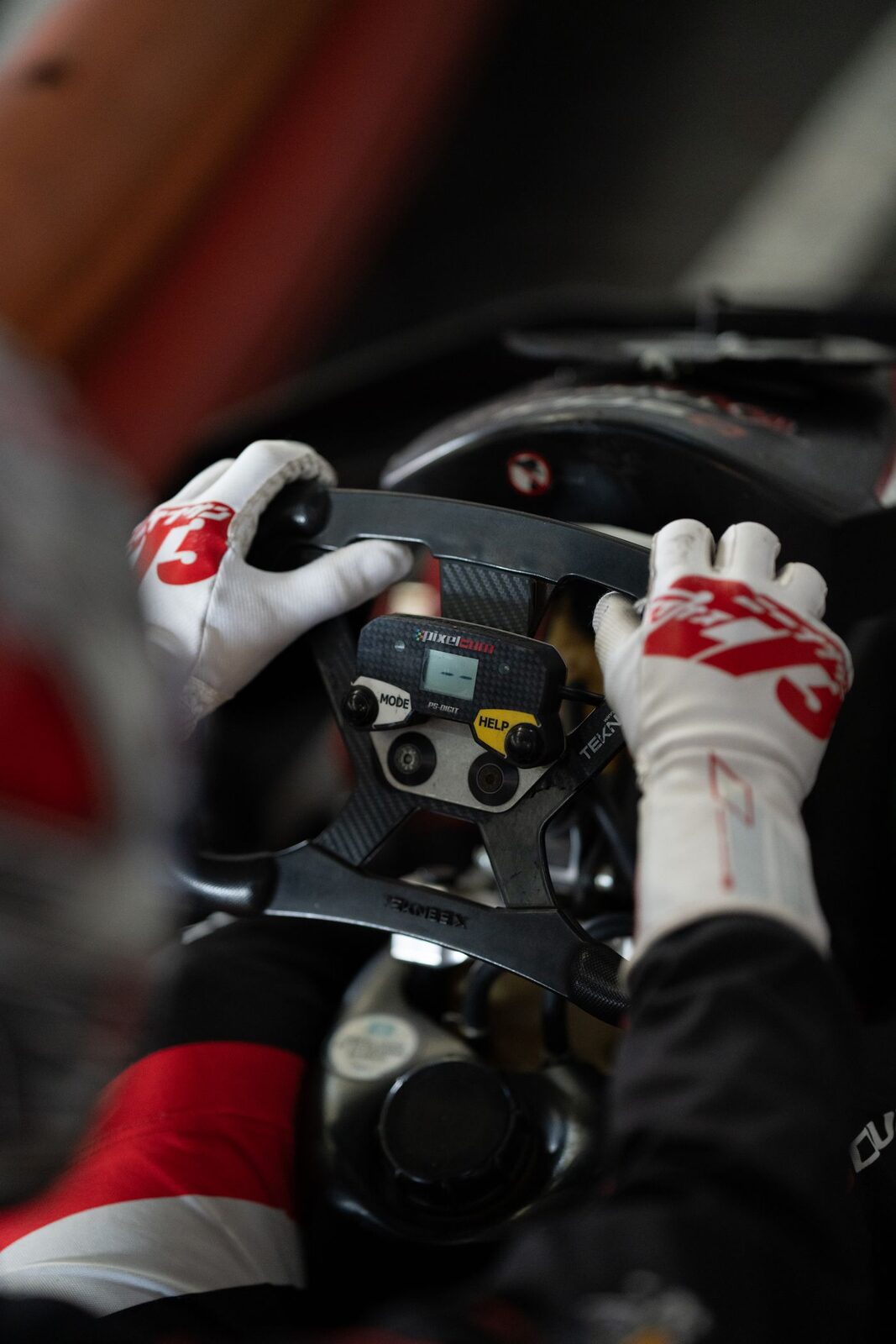 Close-up of a racing wheel rim with control buttons